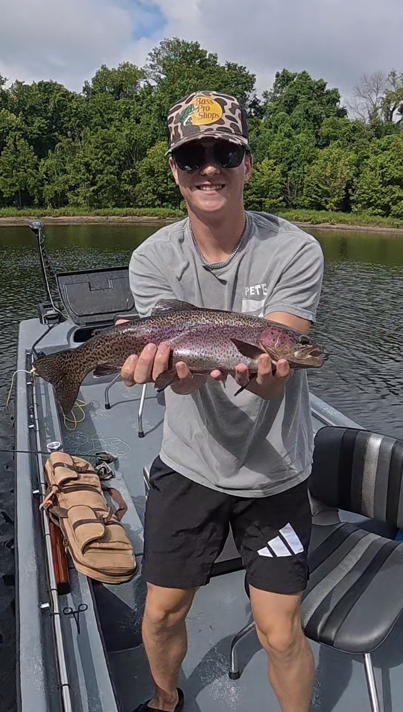 Angler holding a rainbow trout caught on Lake Taneycomo